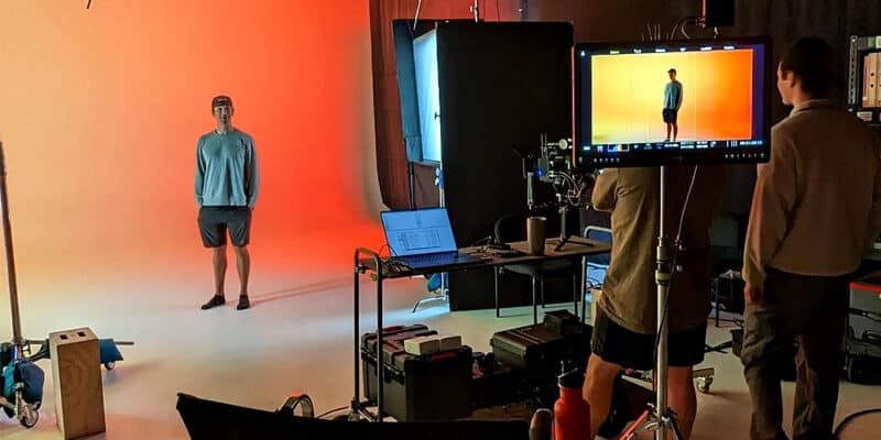 Man being photographed against a coloured background in a Pixthis stage